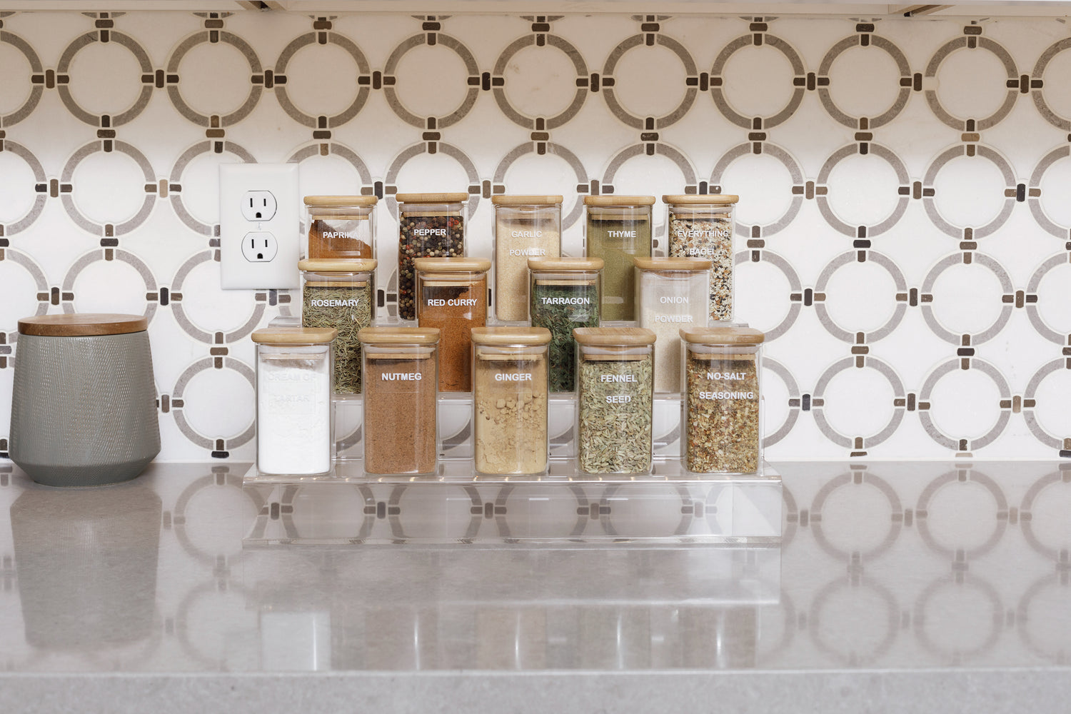 Stunning acrylic spice rack holding a variety of spices in clear containers.