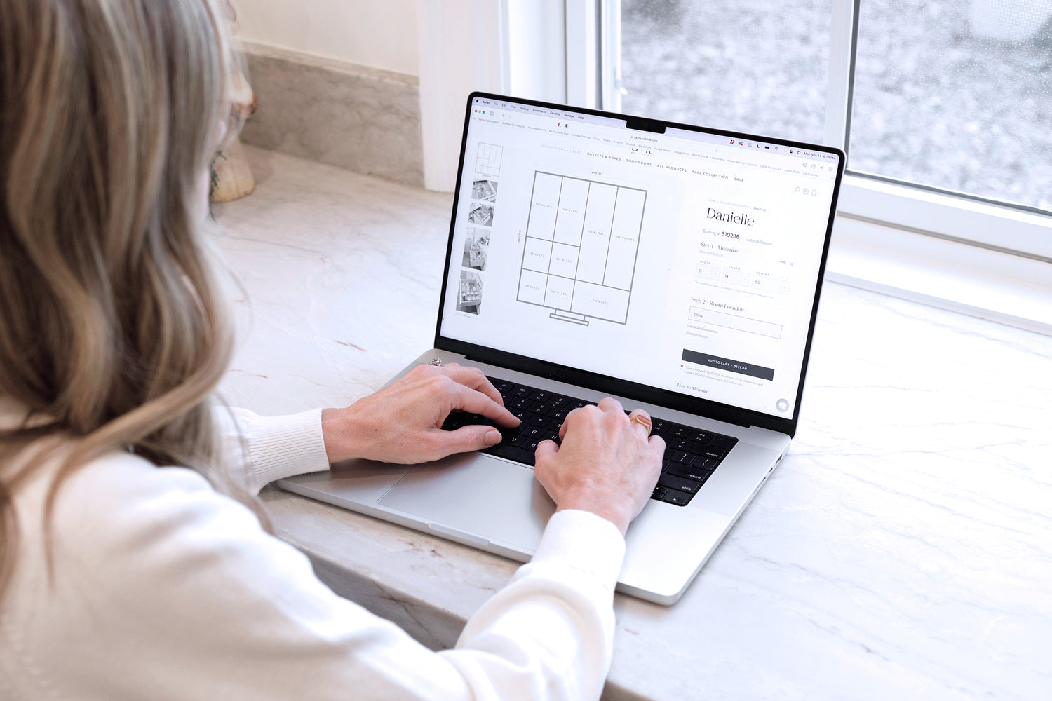 A woman viewing the Danielle organizer on the Salt by Sabrina website from her laptop.