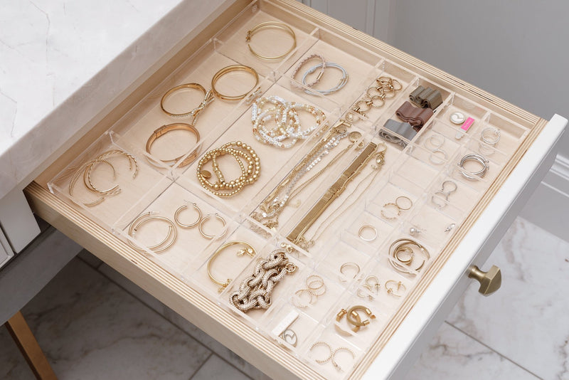 Open bathroom drawer showcasing the Scarlet custom-fit organizer filled with beautiful gold jewelry.