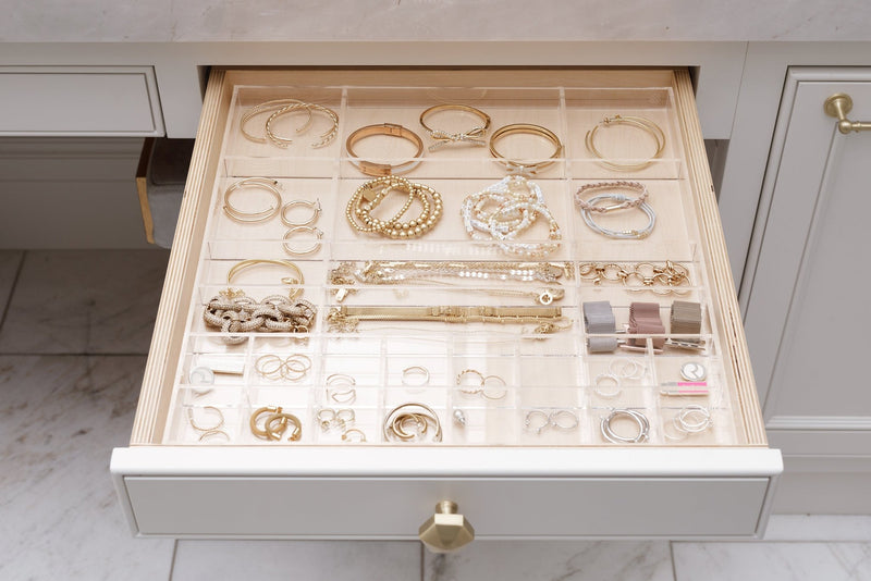Open bathroom drawer showcasing the Scarlet custom-fit organizer filled with beautiful gold jewelry.