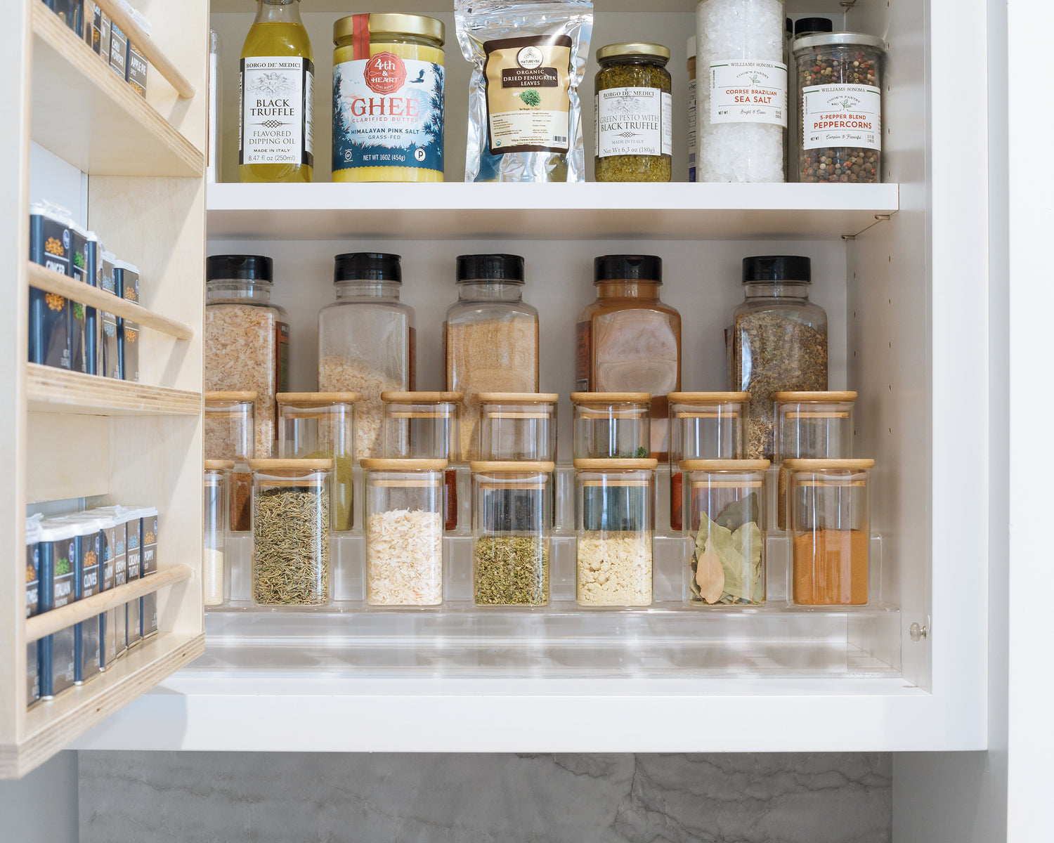 Acrylic Spice Rack holding a set of Spice Jars in the cabinet. 