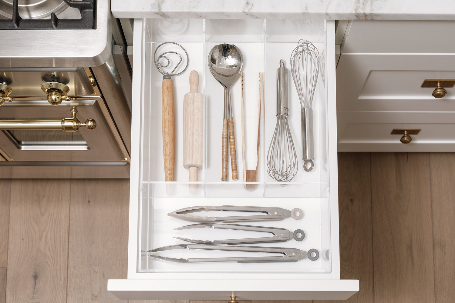 Stunning kitchen drawer with utensils neatly tucked away in a custom-fit organizer.