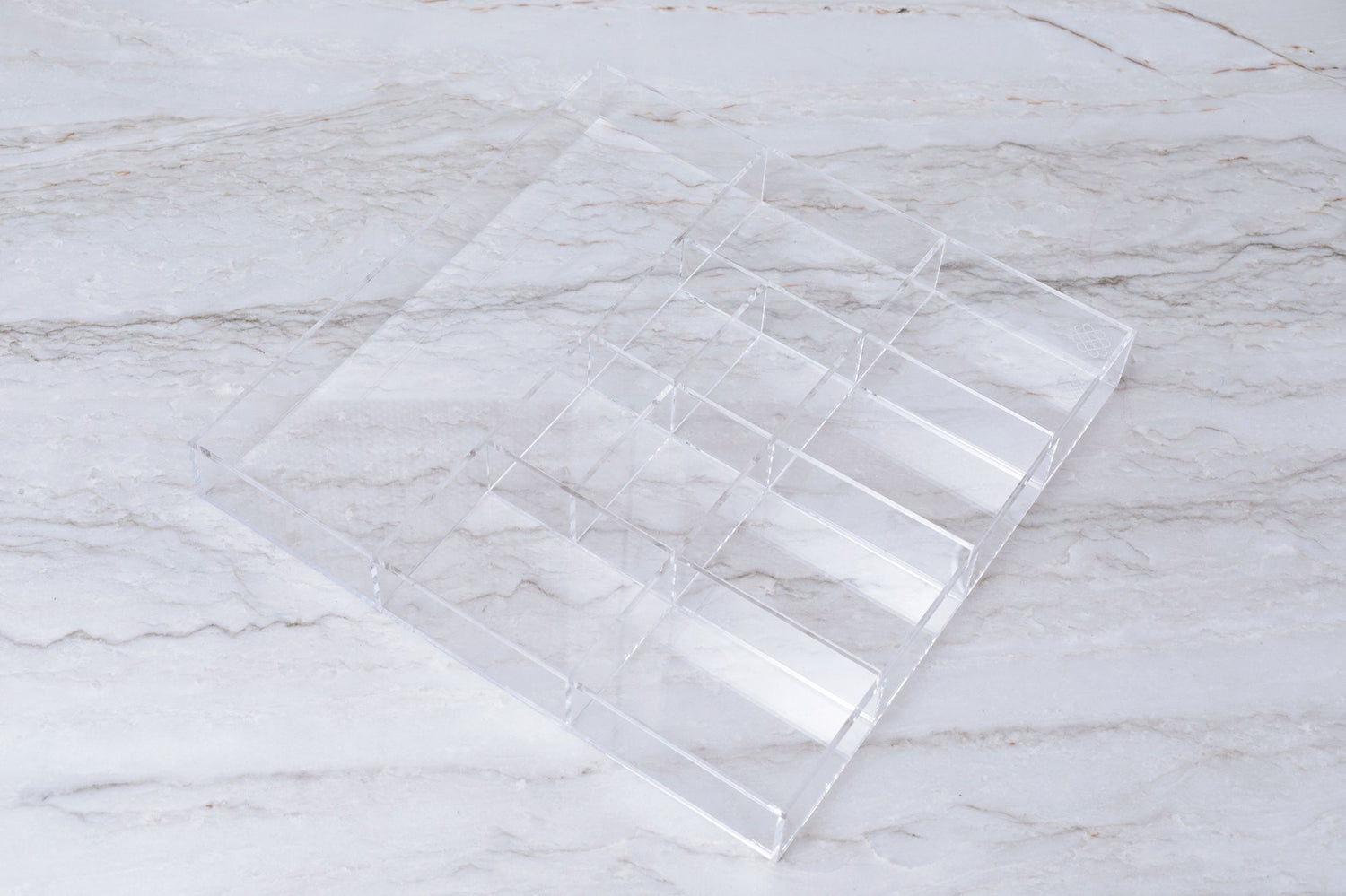 Studio image of an acrylic custom-fit drawer organizer.