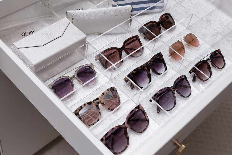 Sunglasses drawer with a clear acrylic custom-fit organizer holding space for each pair.
