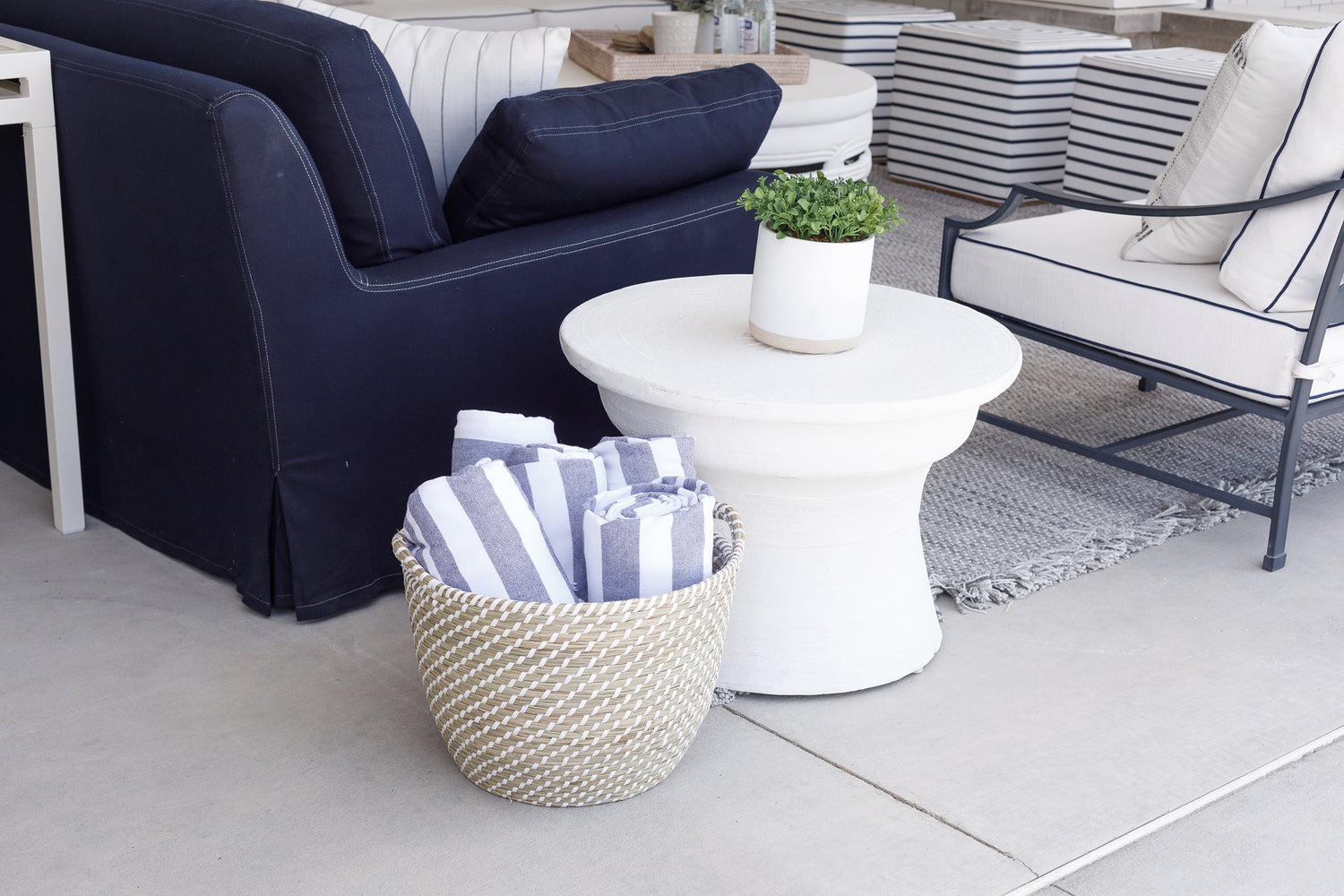 Beach towels on the patio contained within a Bondi Beach basket.