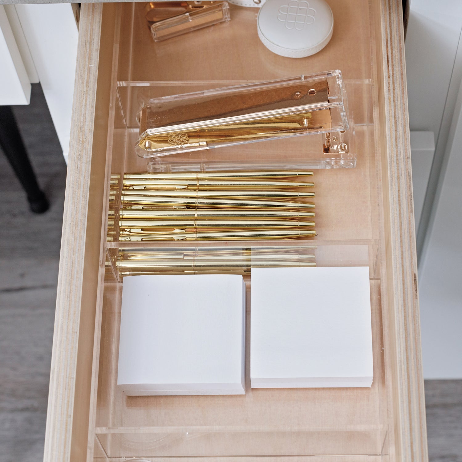 Office products stocked and organized in a drawer with a custom-fit organizer.