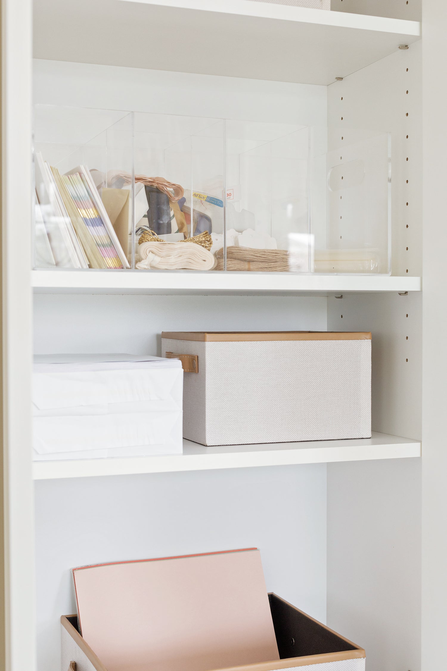 Organized craft cabinet with an acrylic caddy and two Brisbane boxes.