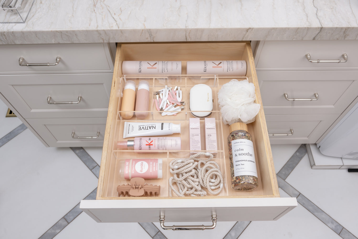 Bathroom drawer organized to perfection with an acrylic Expandable Drawer Organizer.