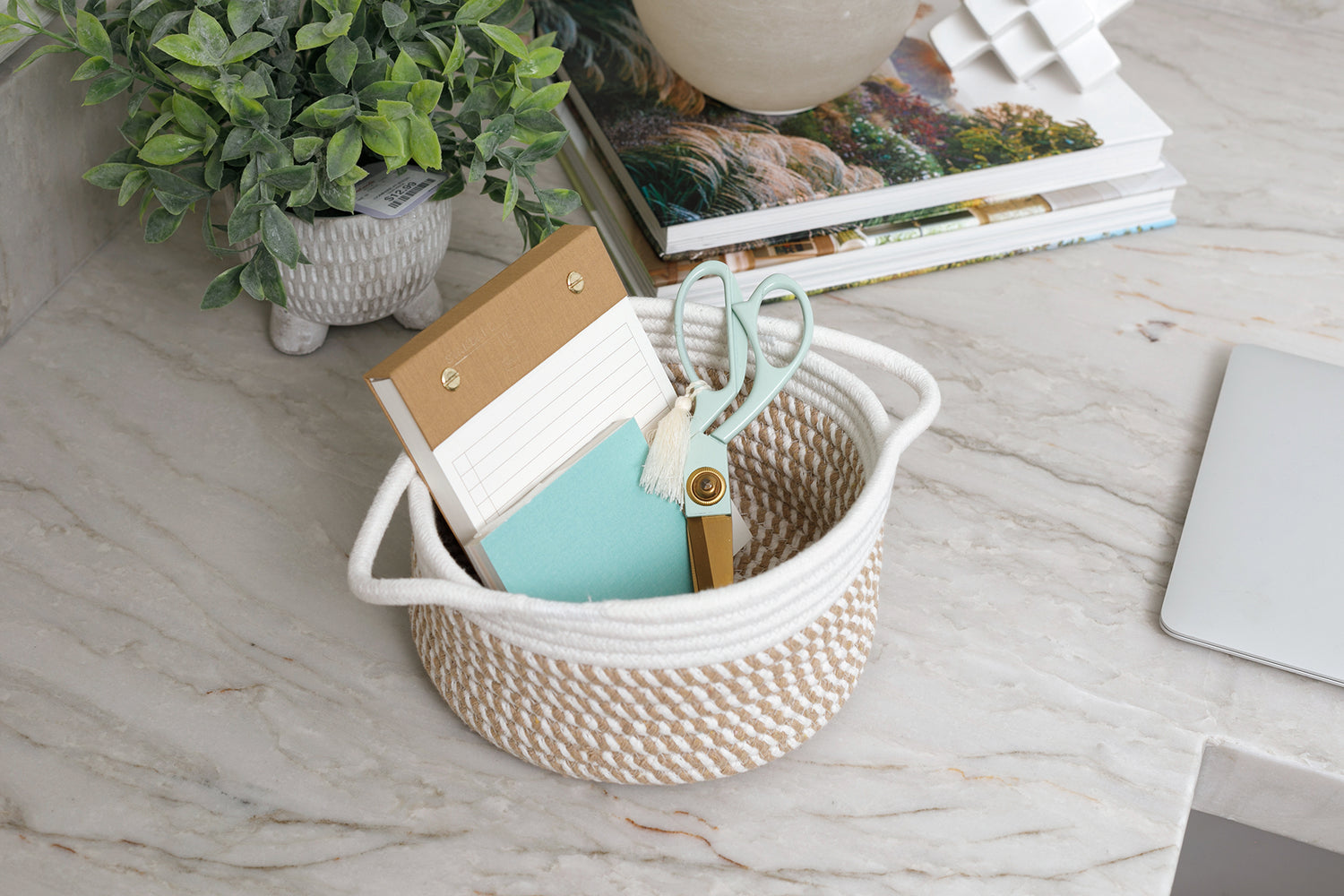 Small Gold Coast basket holding notepads and a pair of scissors. 