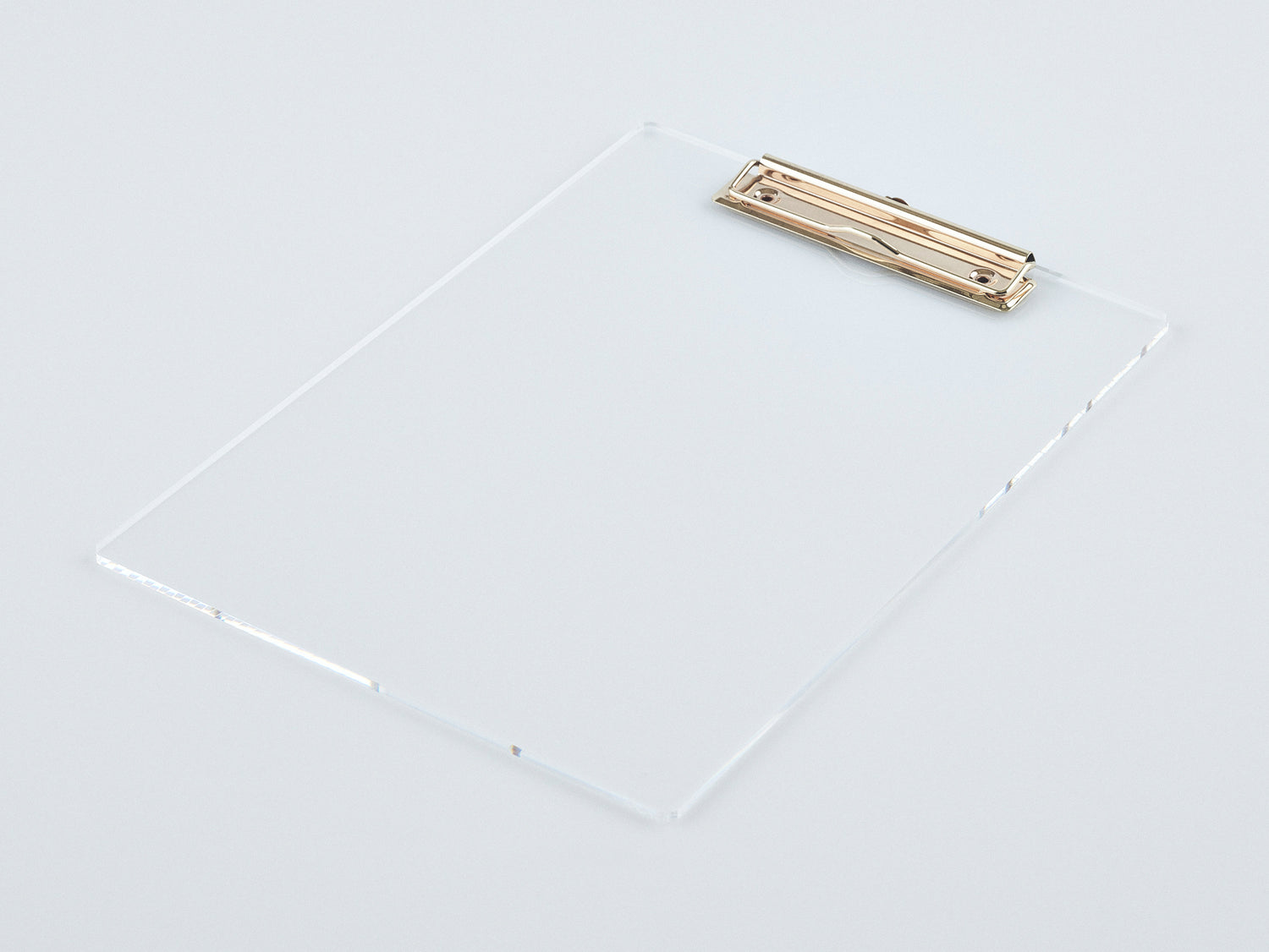 Studio image of an acrylic and gold clipboard.
