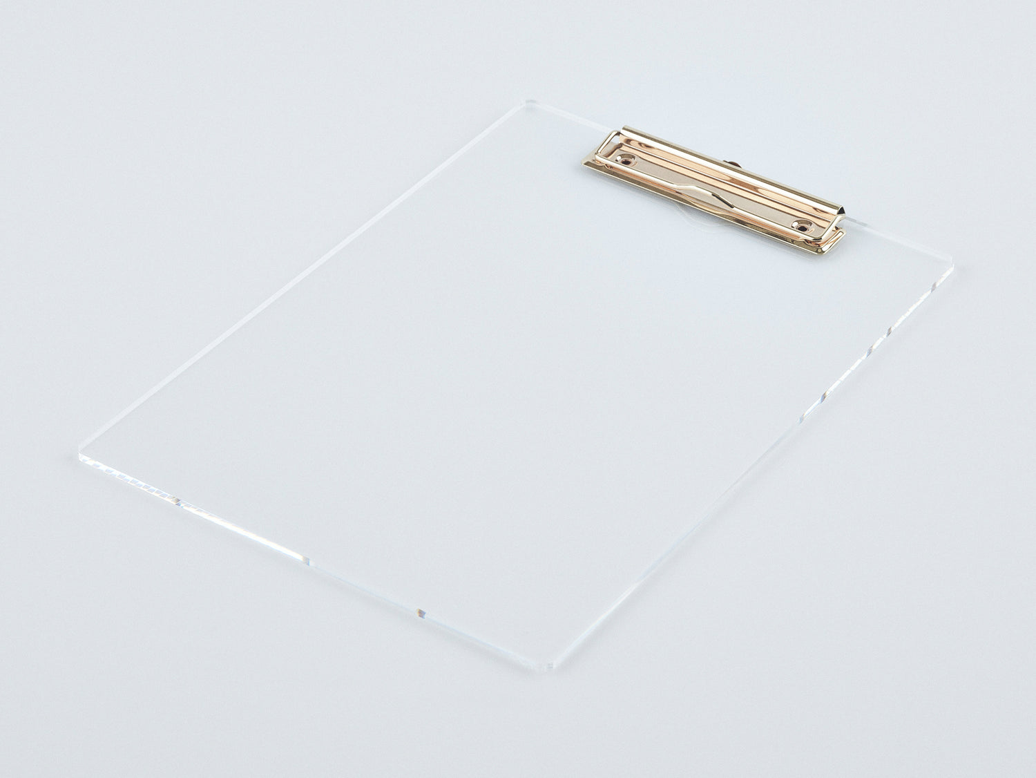 Studio image of an acrylic and gold clipboard. 