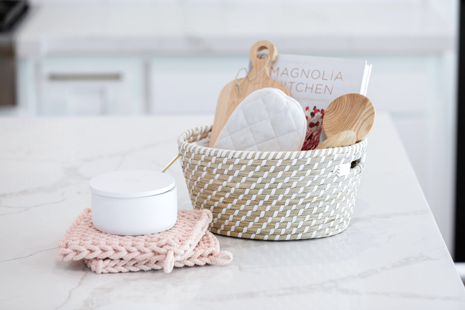 Lovely view of a stocked White Haven basket and Salt Container on the kitchen countertop.