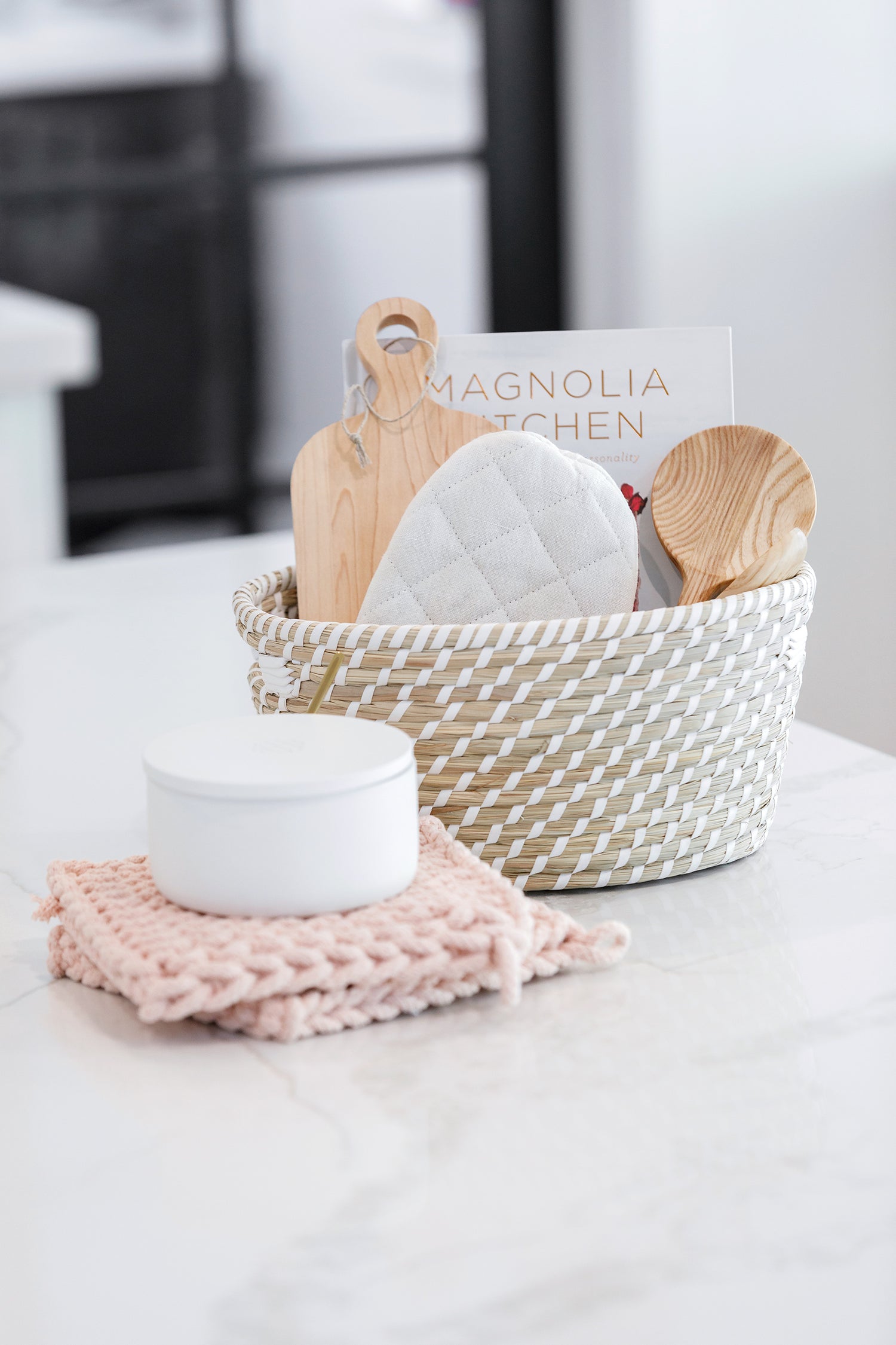 Lovely view of a stocked White Haven basket and Salt Container on the kitchen countertop.