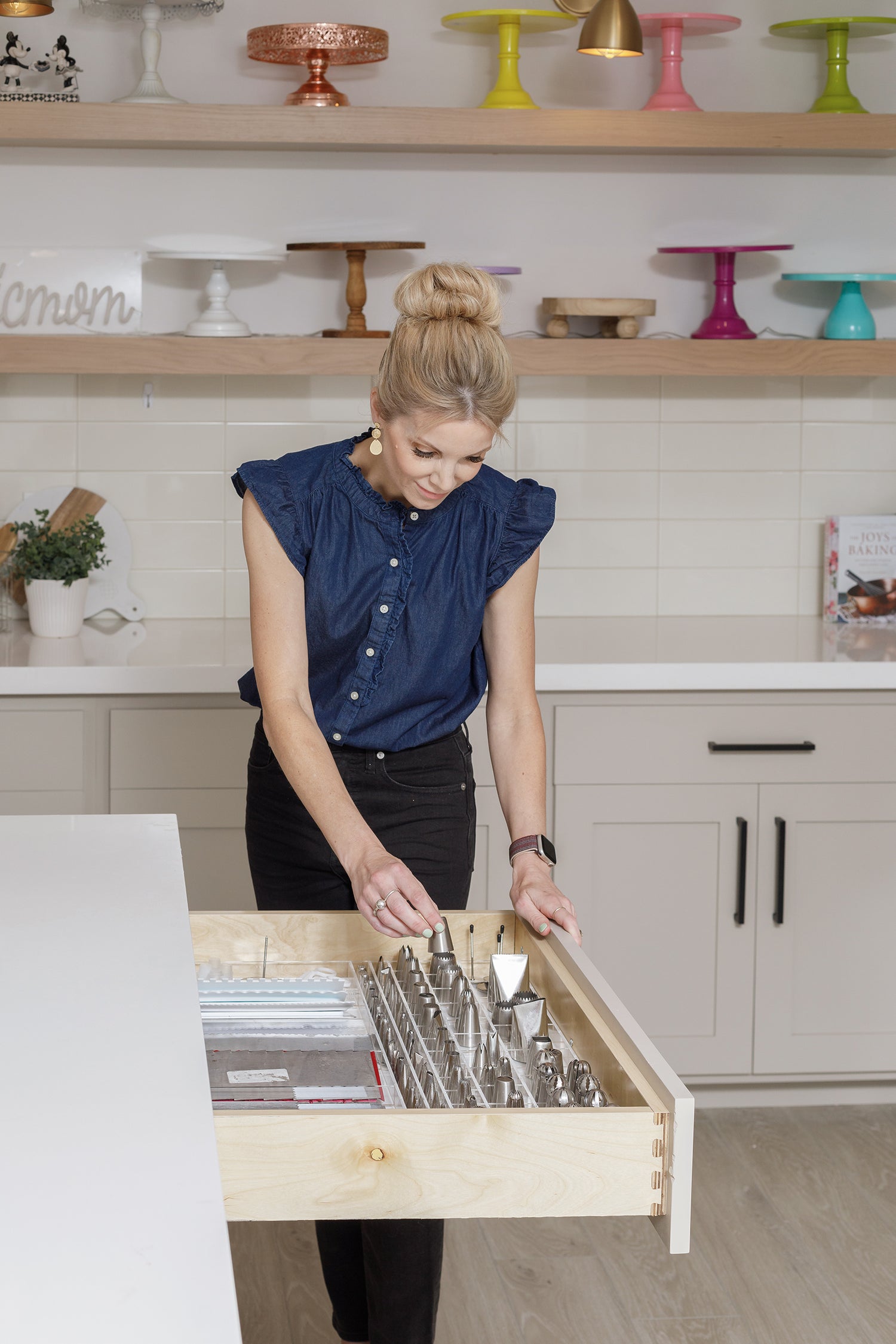 Amy selecting a piping tip from her custom-fit organizer in her kitchen drawer.