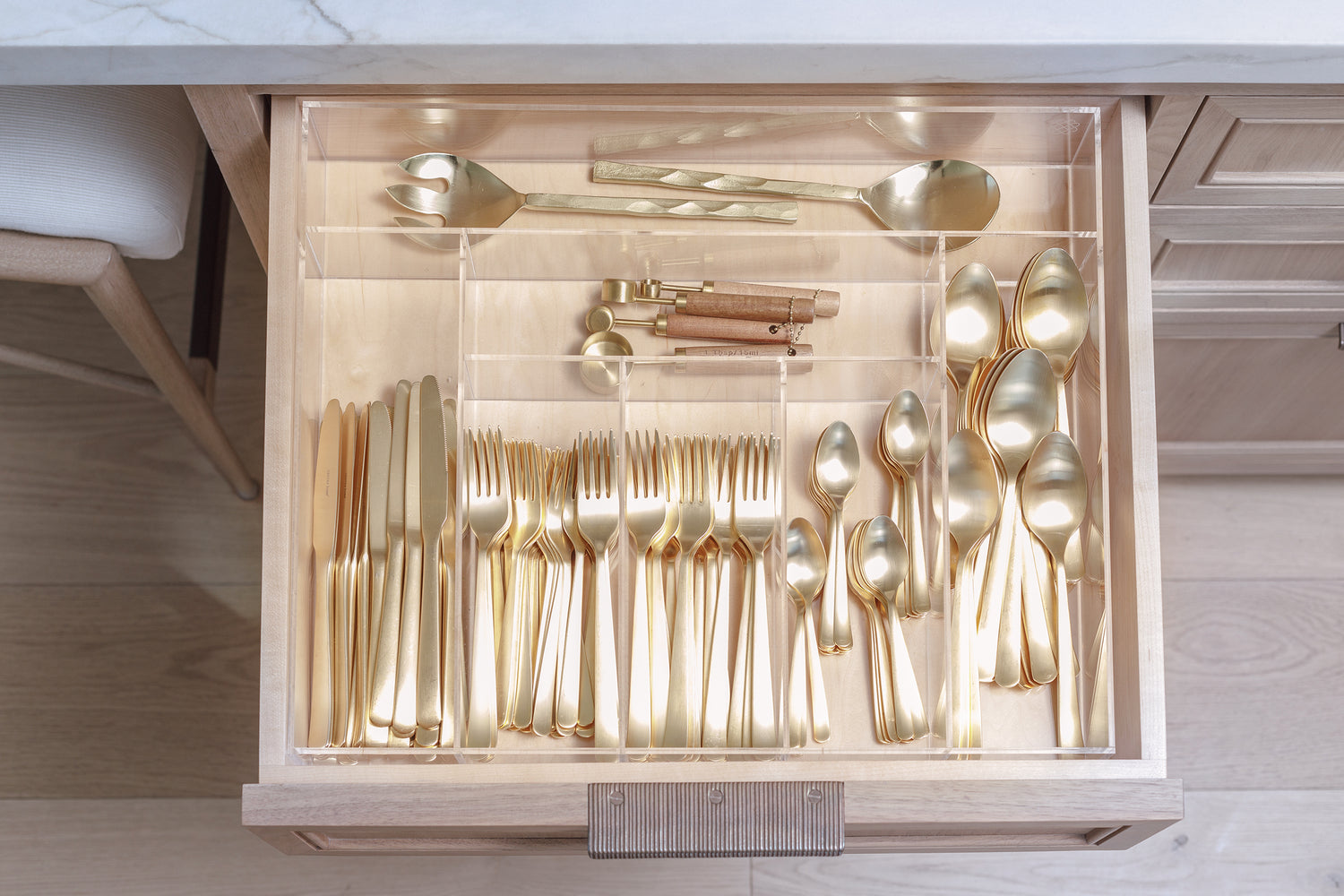 Beautiful kitchen cutlery drawer using the Susan custom-fit acrylic organizer to keep things tidy.