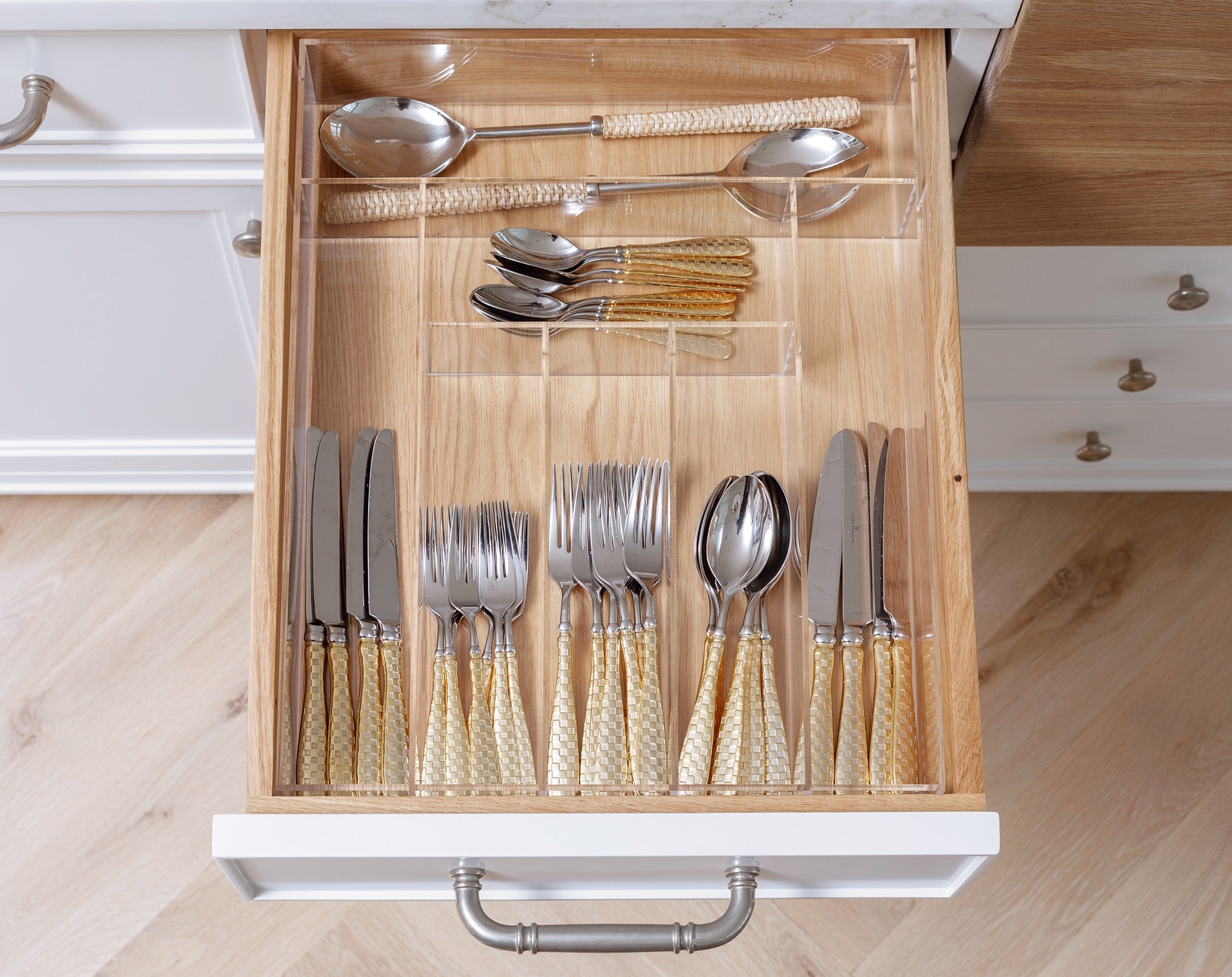 Neat and organized kitchen silverware drawer. 