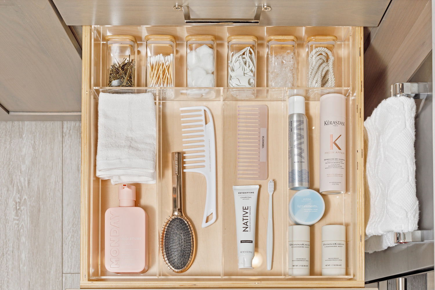 Immaculate bathroom drawer containing combs, hair products, and lotion all organized in the Karena custom-fit organzier.